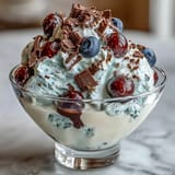 Creamy Greek yogurt layered with sweet mixed berries and dark chocolate shavings for a refreshing treat.
