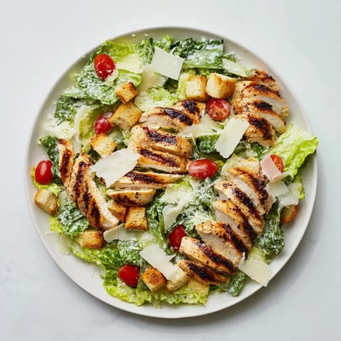 Chopped romaine, cherry tomatoes, and crunchy croutons topped with shaved Parmesan cheese.