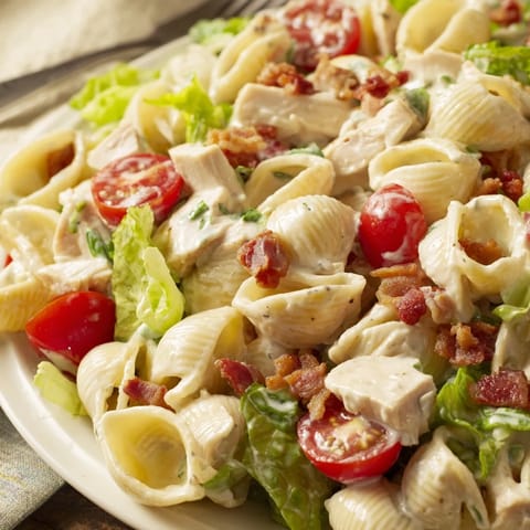 Bright cherry tomatoes and crisp romaine lettuce top tender pasta shells in this BLT Chicken Pasta Salad.