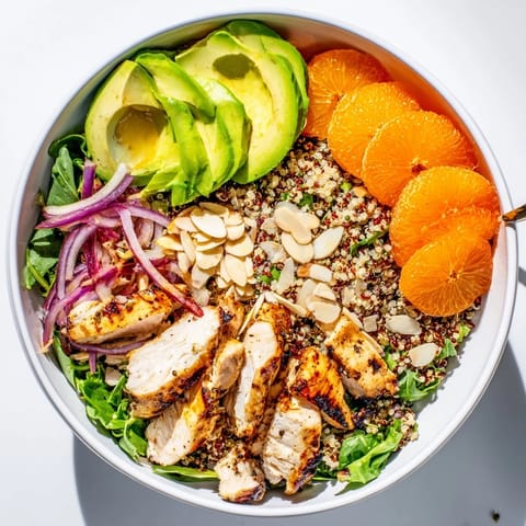 Juicy grilled herb chicken rests on fluffy quinoa and mixed greens, making this wholesome Citrus Herb Chicken Salad Bowl a perfect main dish.
